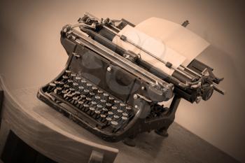 Old typewriter on a small wooden table