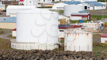 AKRANES, ICELAND - July 27, 2016: White gas storage tank in the west of Iceland on July 27, 2016. Iceland mostly runs on  Geothermal power.