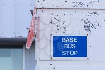 Bus stop sign on a wall, abandoned USAF base on Iceland