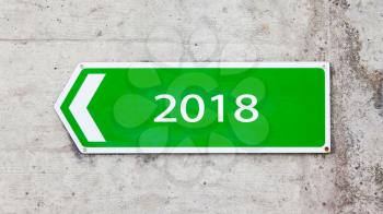 Green sign on a concrete wall - New year - 2018