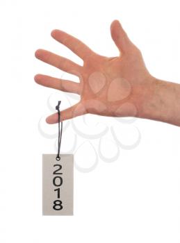 Hand holding a tag, isolated on white - New year - 2018
