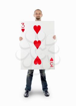 Businessman with large playing card - Three of hearts