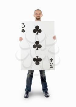 Businessman with large playing card - Three of clubs