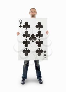 Businessman with large playing card - Nine of clubs