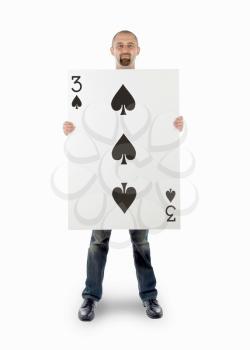 Businessman with large playing card - Three of spades