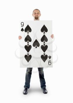 Businessman with large playing card - Nine of spades