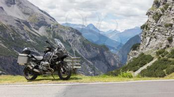Unrecognisable motorcycle and driver in the Alps - Enjoying the scenery