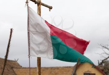 Flag of Madagascar waving in a Malagasy village