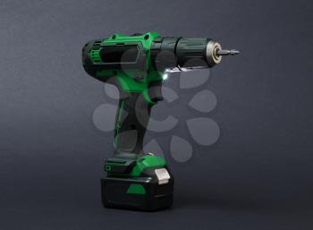 Cordless screwdriver or power drill isolated on a black background