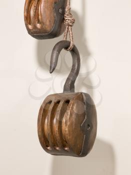 Old wooden pulley, isolated on a white wall