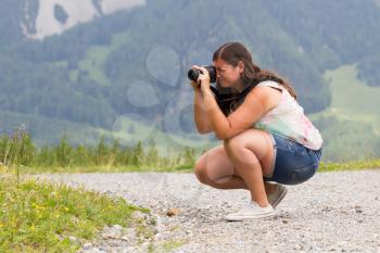 Woman photographing in the mountains
