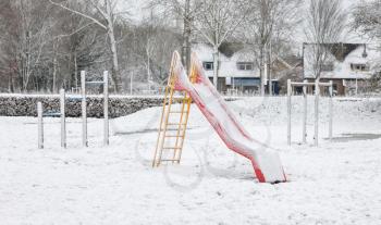 Playground in kindergarten for children in winter with snow - Slide