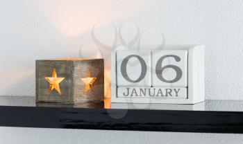 White block calendar present date 6 and month January on white wall background