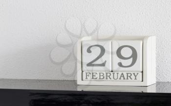 White block calendar present date 29 and month February on white wall background