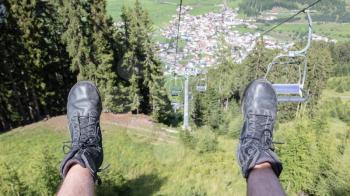 Male hiker riding a chairlift - Summer in Austria