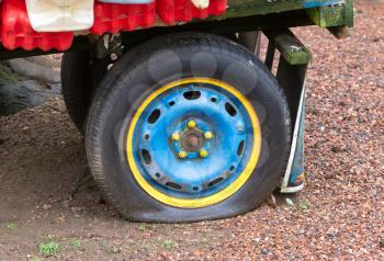 Flat rear tire on a colorful truck