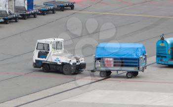 AMSTERDAM - JUNE 29, 2017: Planes are being loaded at Schiphol Airport June 29, 2017 in Amsterdam, The Netherlands. The airport handles over 45 million passengers per year with almost 100 airlines flying from here.