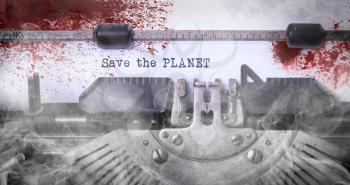 Save the planet, bloody, written on an old typewriter, vintage