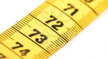 Close-up of a yellow measuring tape isolated on white - 73 - Selective focus