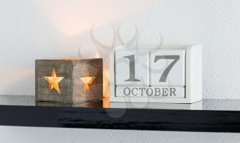 White block calendar present date 17 and month October on white wall background