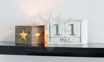 White block calendar present date 11 and month May on white wall background