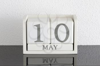 White block calendar present date 10 and month May on white wall background