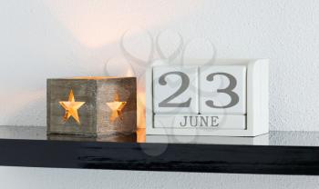 White block calendar present date 23 and month June on white wall background