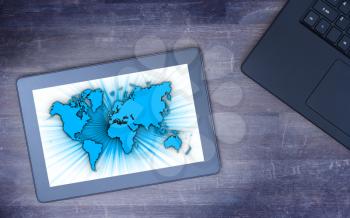 World map on a tablet, concept of globalisation, cold blue filter