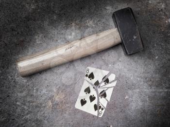 Hammer with a broken card, vintage look, eight of spades