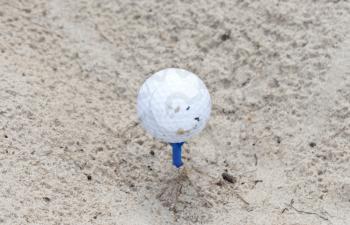 Golf ball waiting to be used, sand