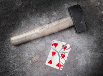 Hammer with a broken card, vintage look, six of hearts