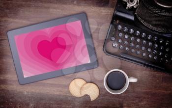 Heart shape backgound on a tablet - Concept of love - pink