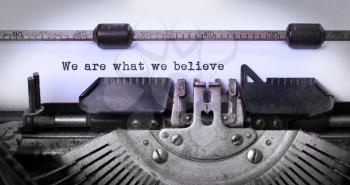 Vintage inscription made by old typewriter, we are what we believe