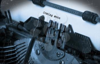 Close-up of an old typewriter with paper, perspective, selective focus, coming soon