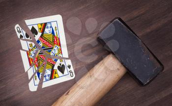 Hammer with a broken card, vintage look, queen of spades