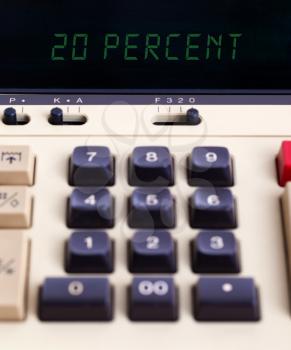 Old calculator with digital display showing a percentage - 20 percent