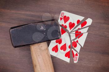 Hammer with a broken card, vintage look, ten of hearts