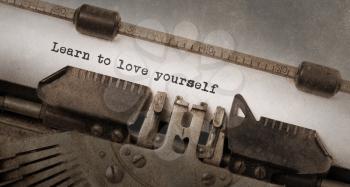 Vintage typewriter, old rusty and used, learn to love yourself
