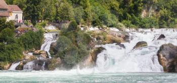 RHEINFALLS, SWITZERLAND - JULY 25, 2015: View to the biggest waterfalls of Europe in Schaffhausen, Switzerland on May 17, 2015. They are 150 m (450 ft) wide and 23 m (75 ft) high.