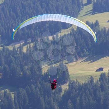 Amateur paraglider gliding in the Swiss mountains