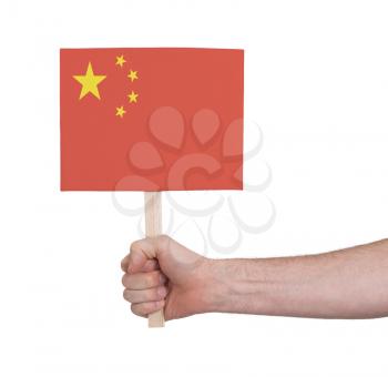 Hand holding small card, isolated on white - Flag of China