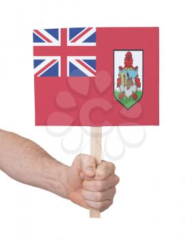 Hand holding small card, isolated on white - Flag of Bermuda
