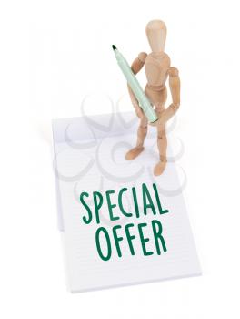 Wooden mannequin writing in a scrapbook - Special offer
