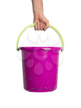 Human hand holding empty plastic pail, isolated on white