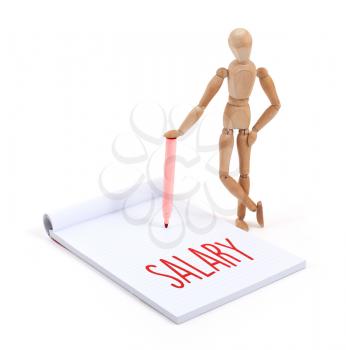 Wooden mannequin writing in a scrapbook - Salary