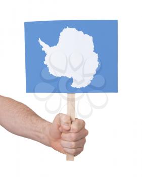 Hand holding small card, isolated on white - Flag of Antarctica