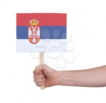 Hand holding small card, isolated on white - Flag of Serbia