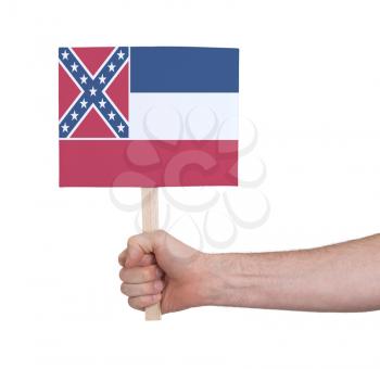 Hand holding small card, isolated on white - Flag of Mississippi