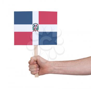 Hand holding small card, isolated on white - Flag of Dominican Republic