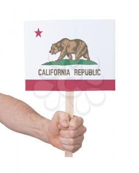 Hand holding small card, isolated on white - Flag of California